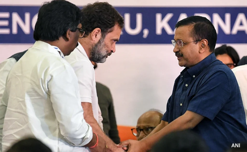 "Rahul Gandhi and Arvind Kejriwal greet each other at a 2024 Lok Sabha election event."