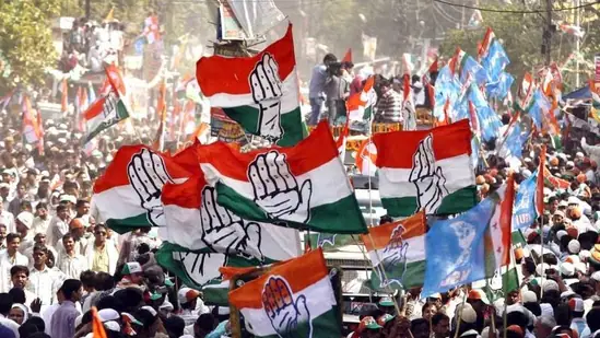 "Vibrant scene of a Congress party rally in India, with supporters waving party flags, showcasing the political fervor of the 2024 Lok Sabha Elections."






